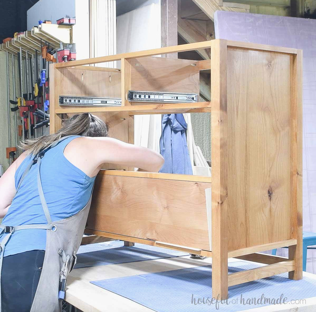Securing the drawer front to the drawer box so it aligns flush with the front frame. 