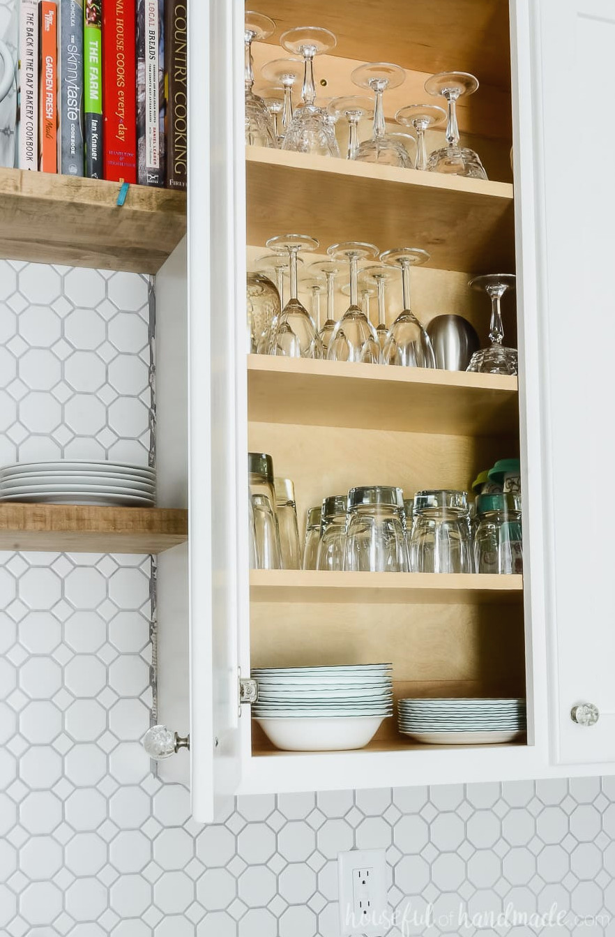DIY 42" upper wall cabinet with one door open showing dishes inside. 