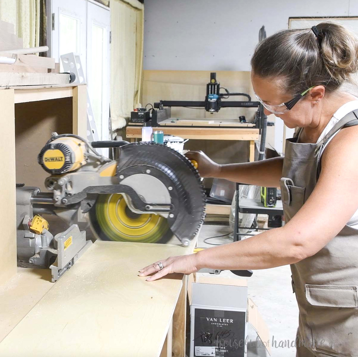 Cross-cutting the plywood pieces with a sliding miter saw.