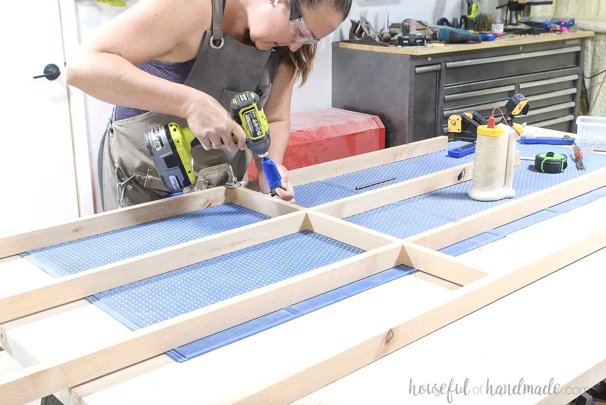 Installing the top and bottom pieces on the front frame.