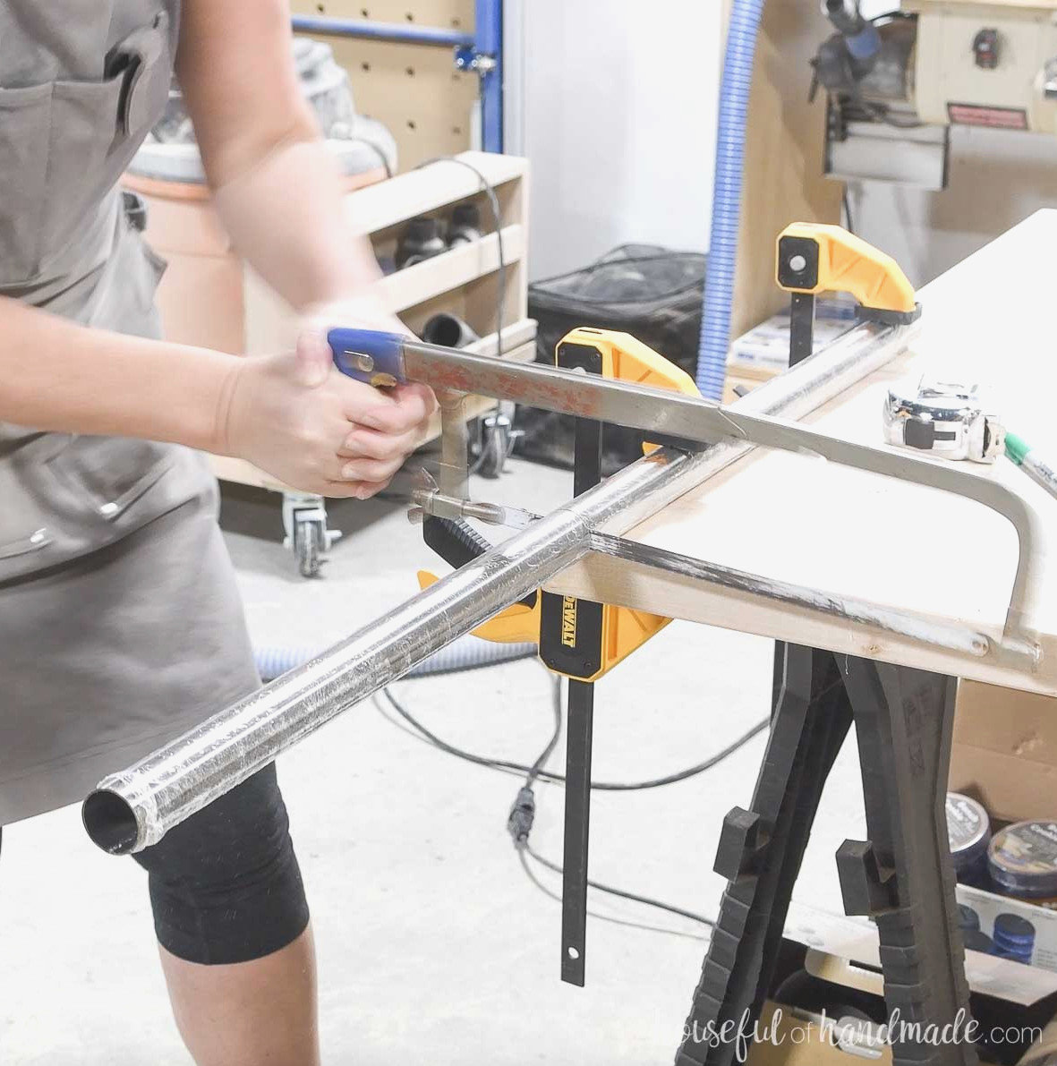 Trimming a metal closet rod with a hacksaw. 
