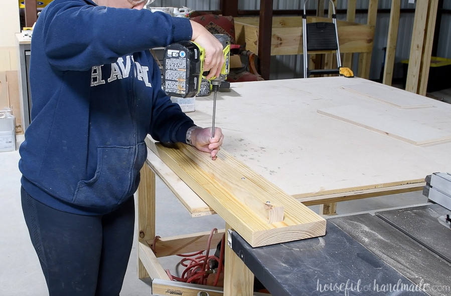 Securing the 2x2 board to the bed rails with 2 1/2" screws.