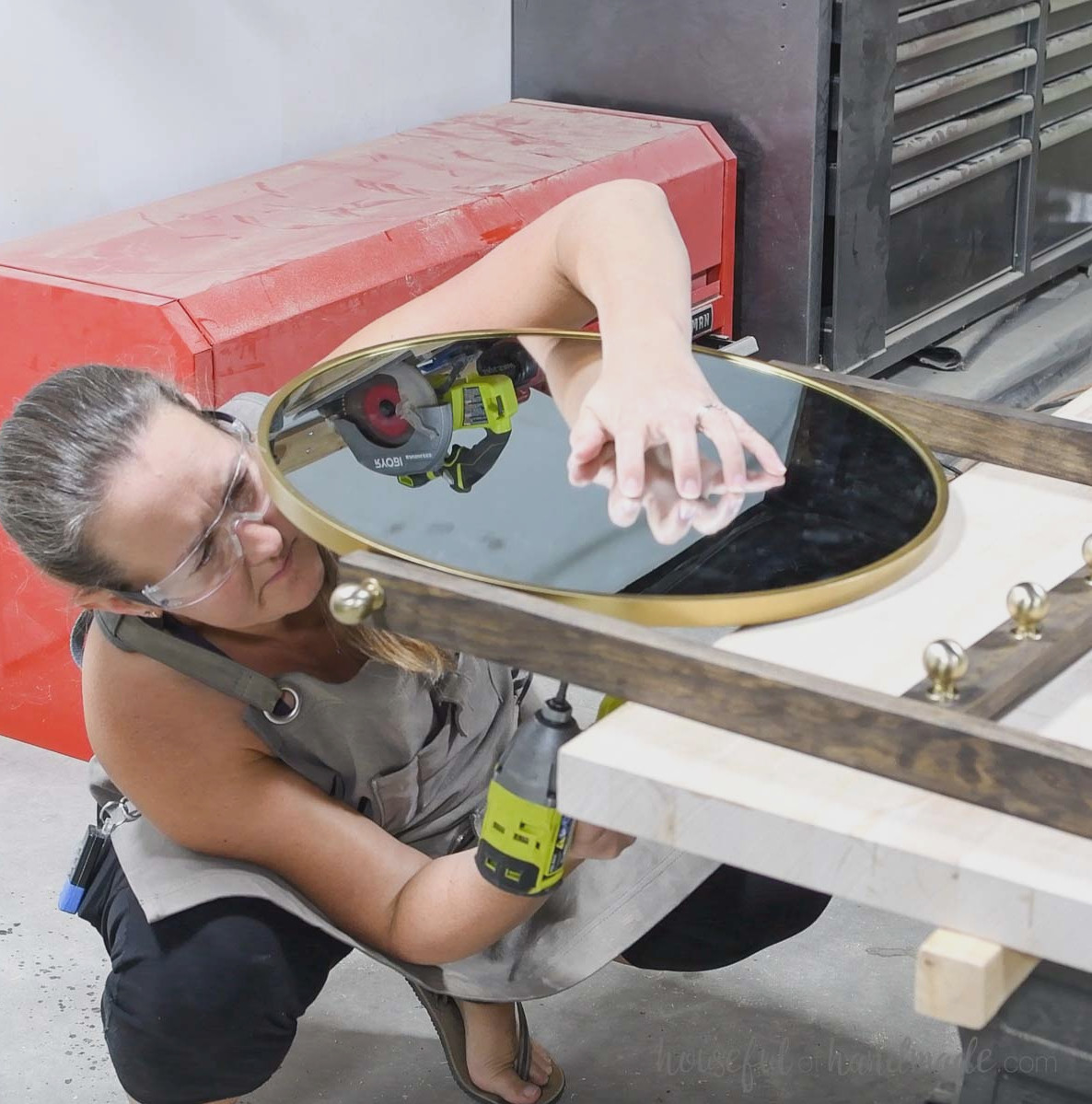 Securing the mirror to the top of the entry ladder.