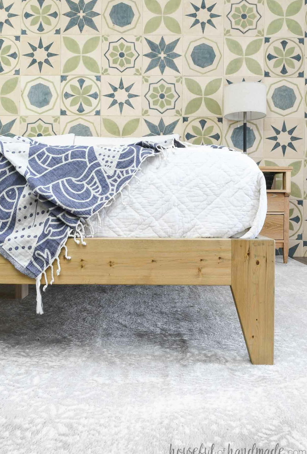 Detailed view of the tapered leg on a platform bed frame built from 2x4 and 2x6 boards.