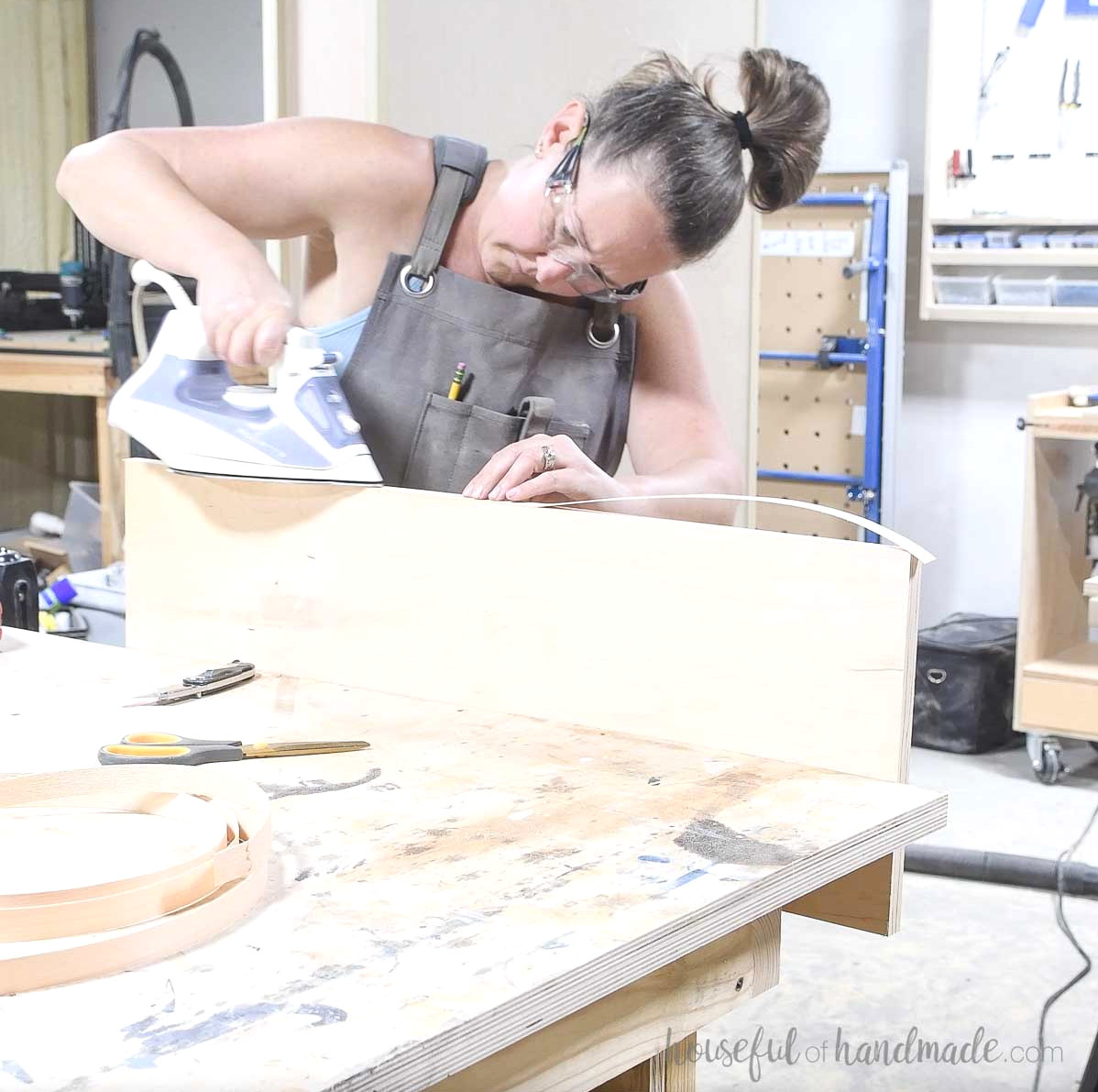 Completing the shelf fronts with iron-on edge banding. 