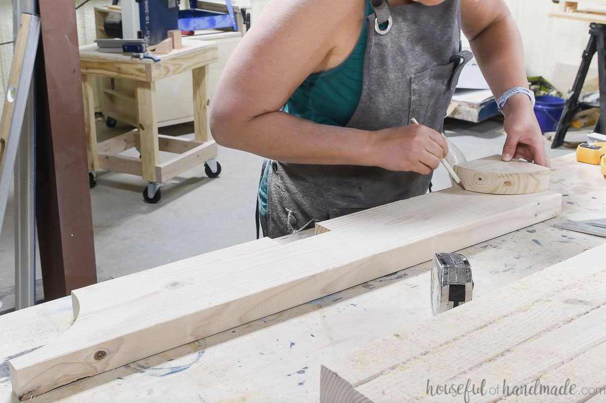 Tracing the curve onto the remaining rafter boards with the piece cut from the first curve.