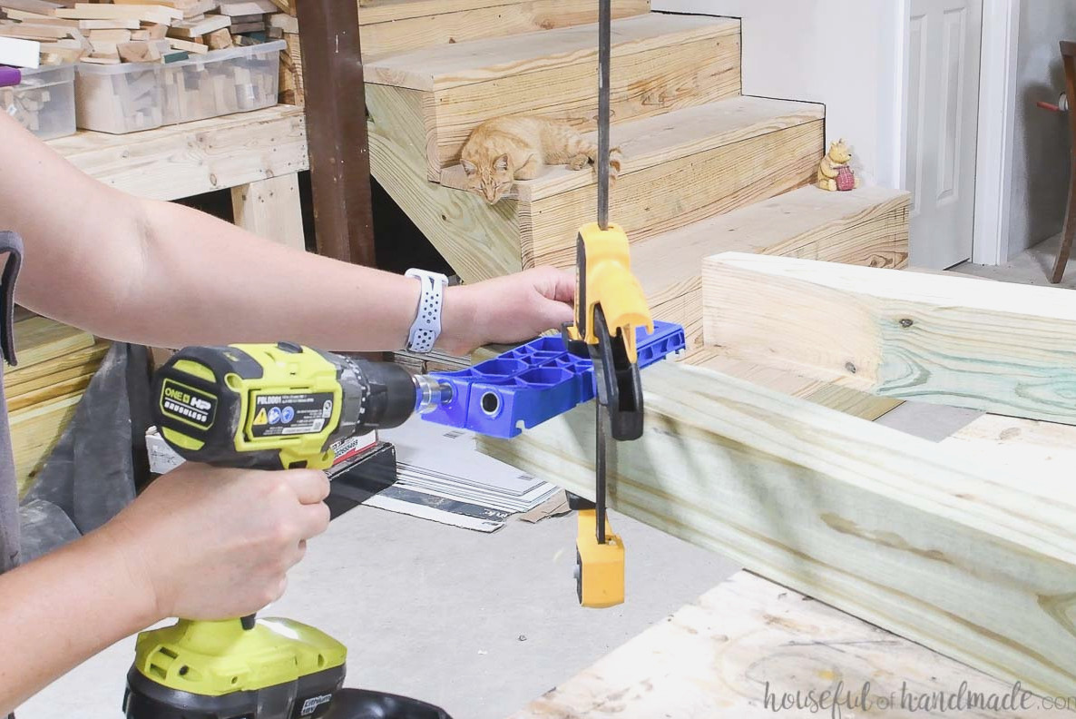 Making a pocket hole in the 4x4 board with the Kreg pocket hole XL jig.