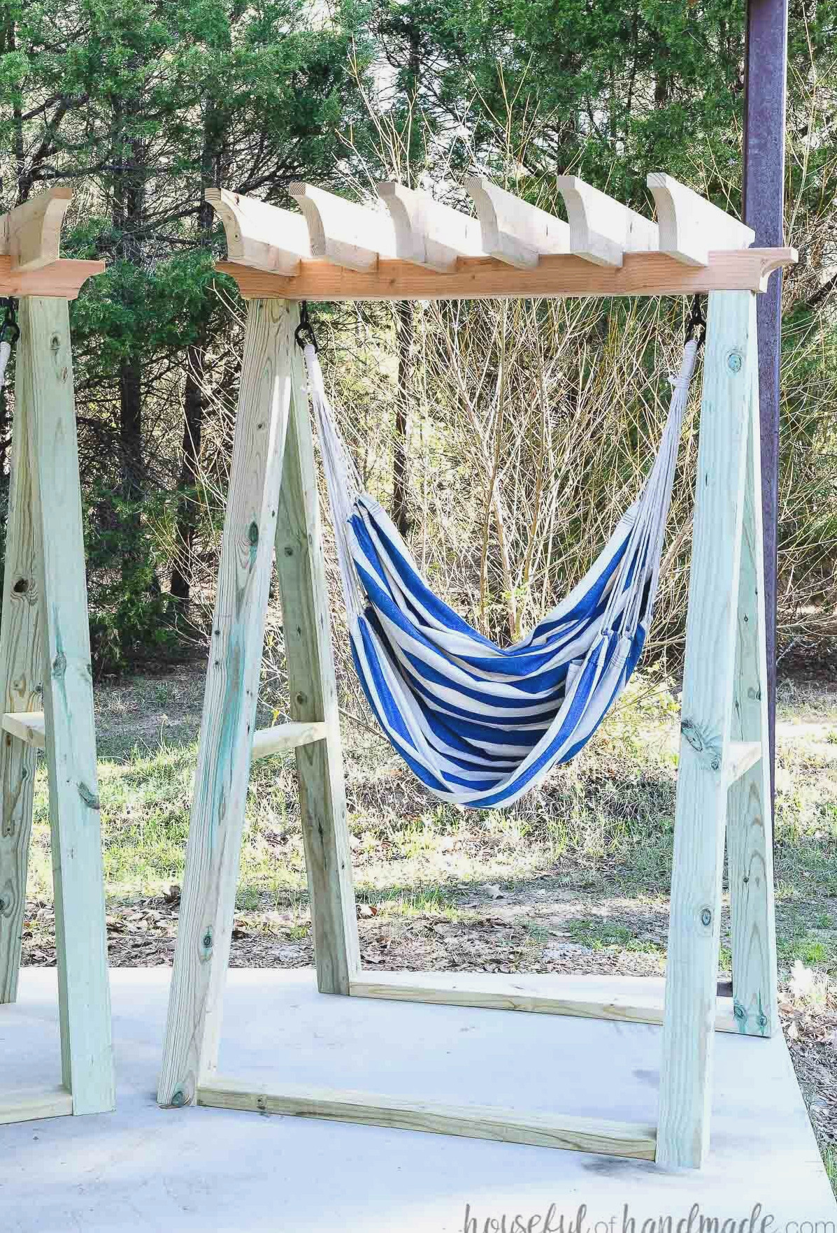 DIY hammock chair stand holding a blue and white striped hammock chair. 