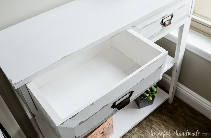 Create a lovely small console table for added storage and home decor. This DIY farmhouse console table features two spacious drawers and two shelves. An ideal storage solution for compact spaces. Housefulofhandmade.com The interior of the spacious top drawer on the small console table. Lots of room for keeping items organized. Housefulofhandmade.com