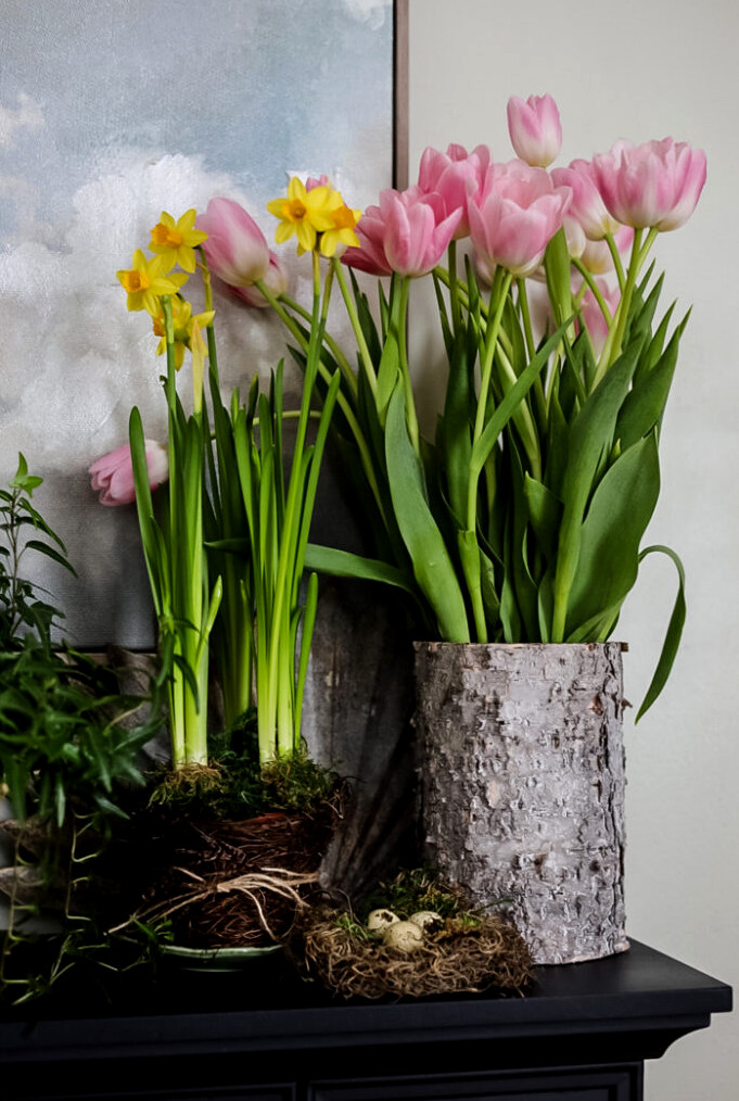 spring display of tulips and daffodils on a mantle