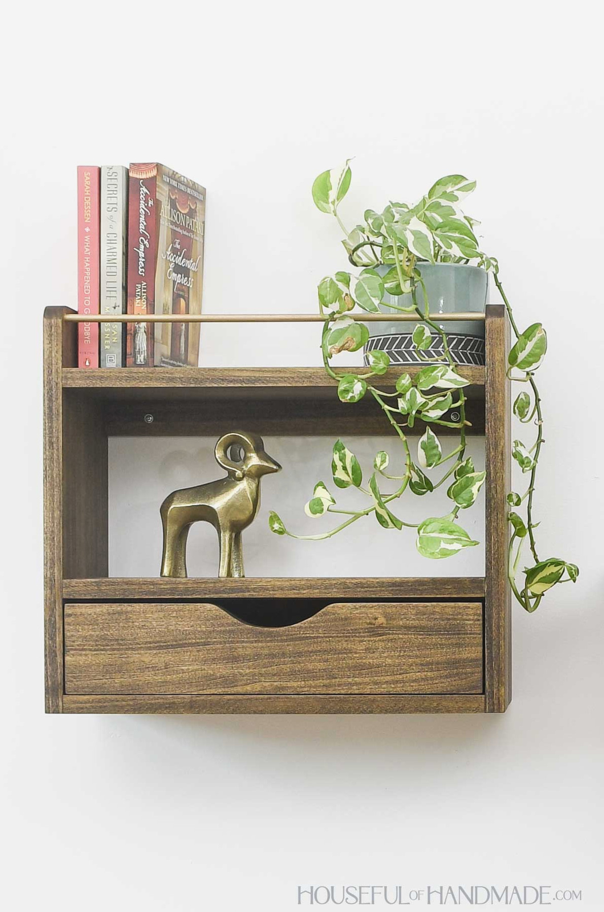 Large DIY wall shelf with a drawer and two shelves with display items. 