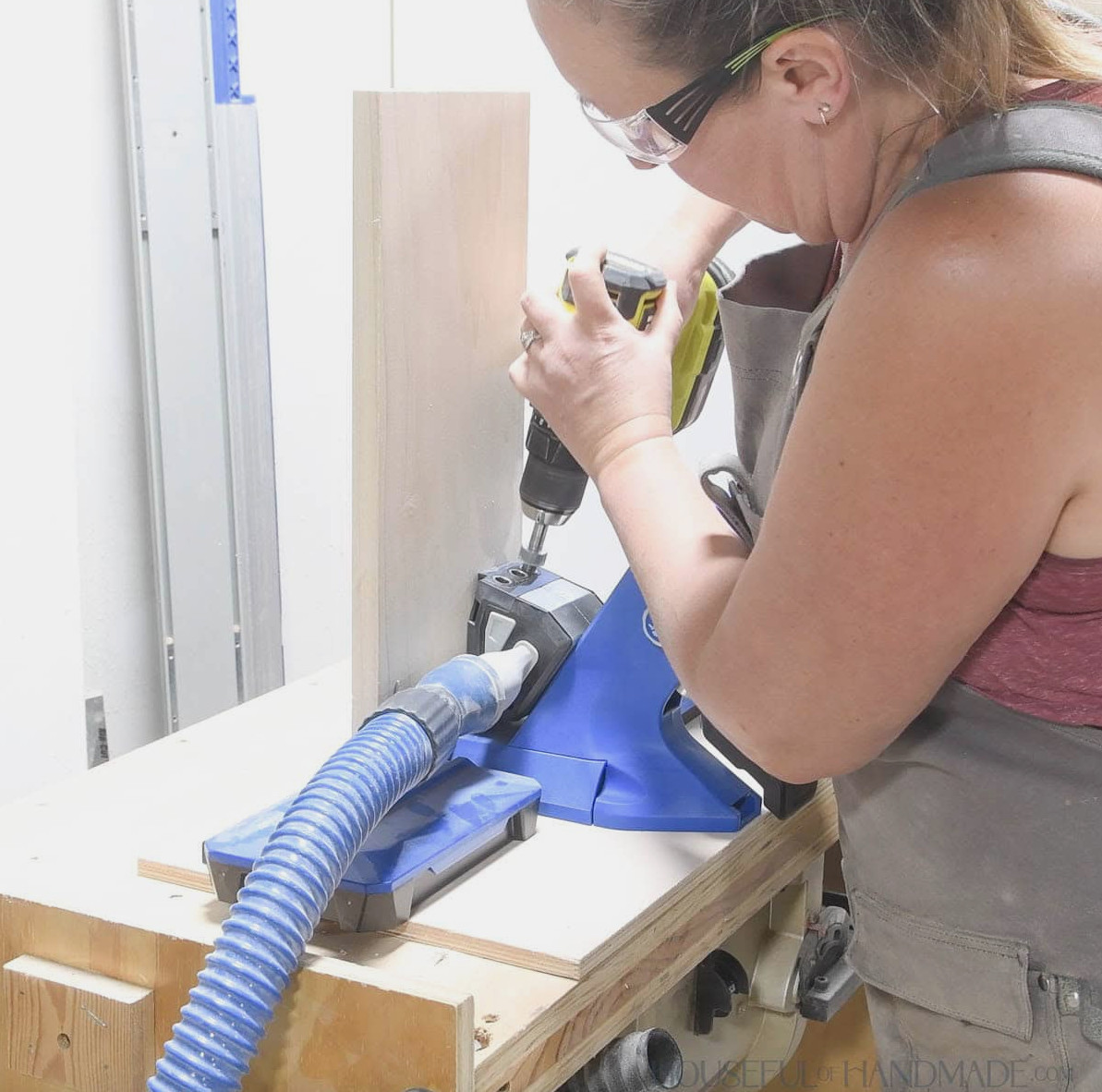 Drilling pocket holes in a board with the Kreg 720 jig. 