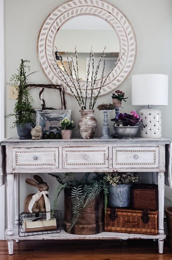 entryway table decorated with vintage pieces