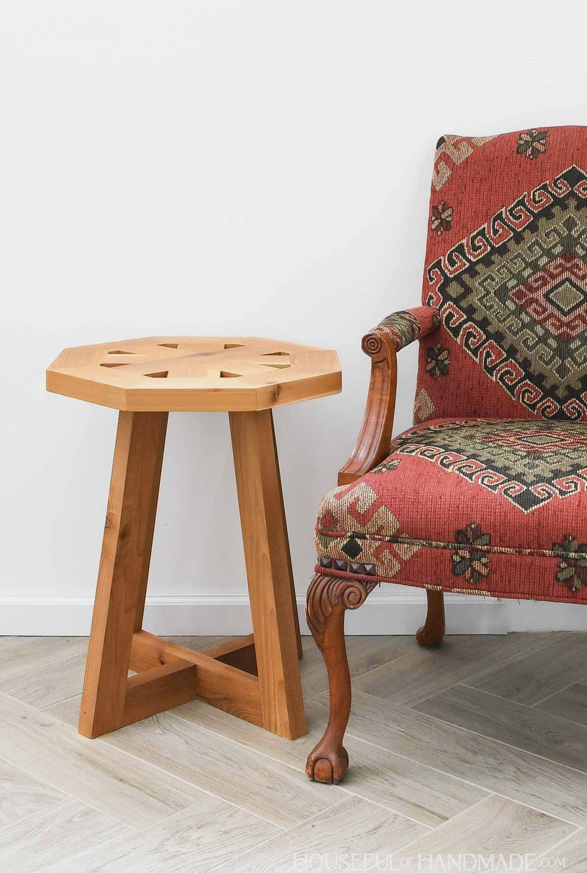Wooden end table featuring an octagonal top and tapered legs.