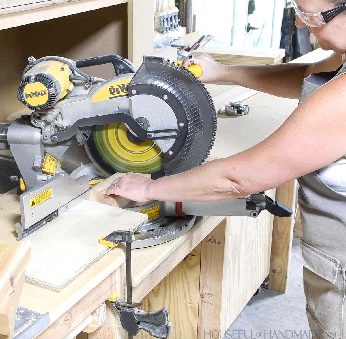 Using a miter saw to cut a 2x4 with angles on both ends.