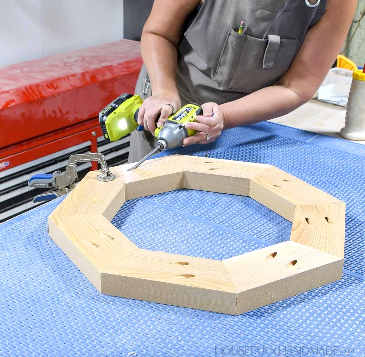 Fitting the eighth board into the wooden octagon.