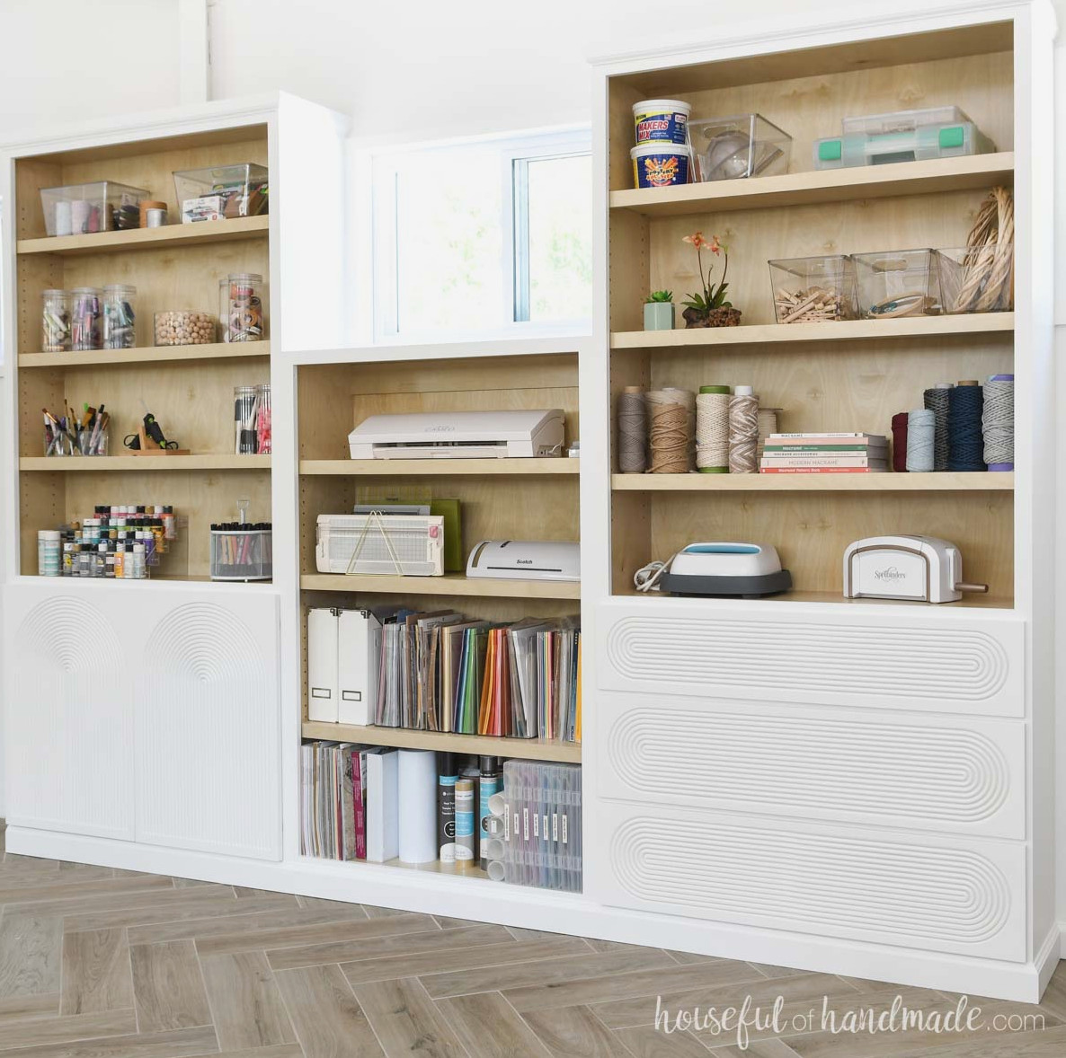 White painted DIY built in storage cabinets with natural wood inside.