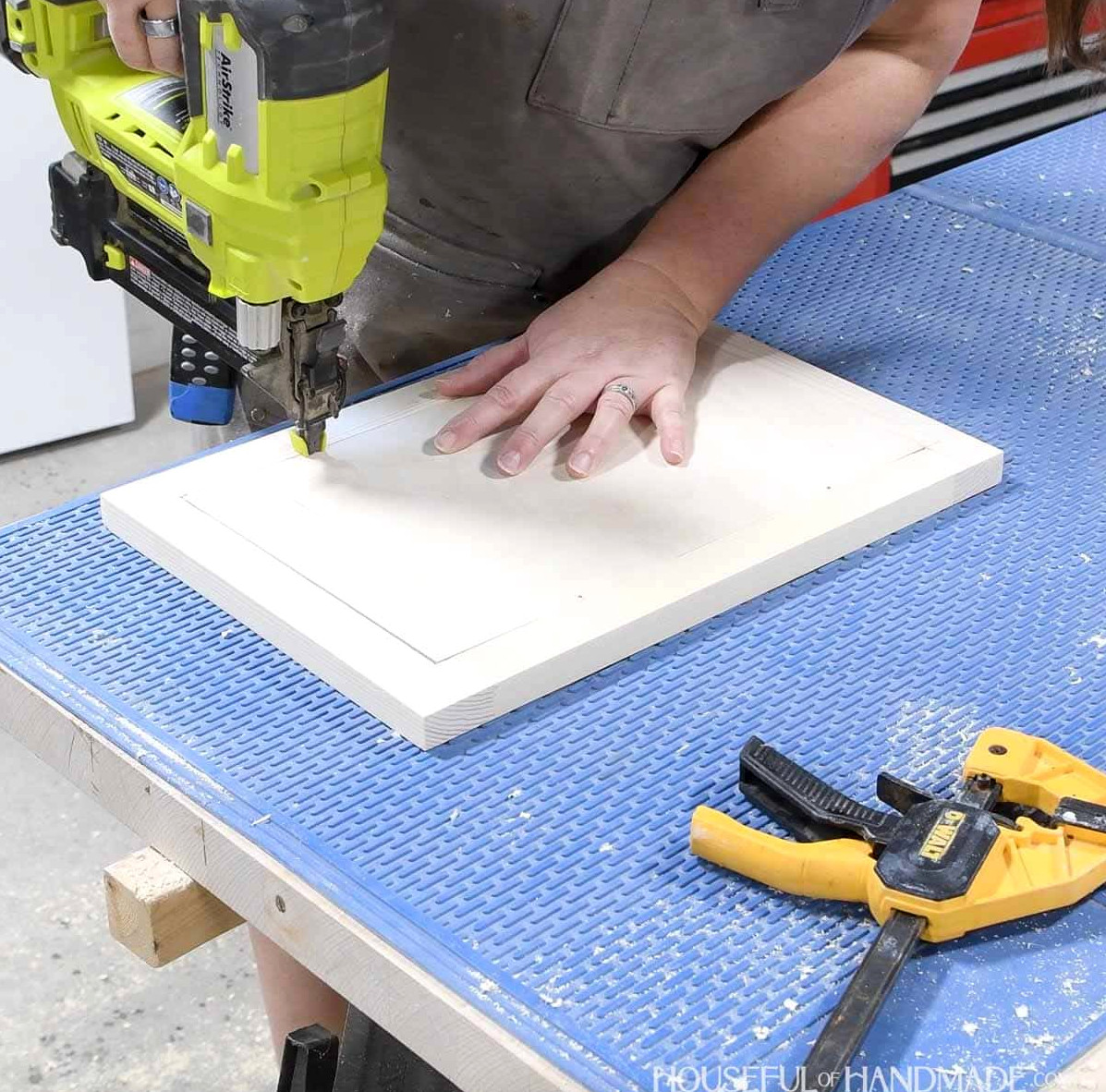 Fastening the door panel with brad nails.