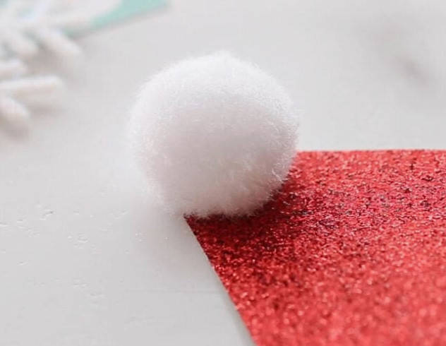Glue white pom pom to hat