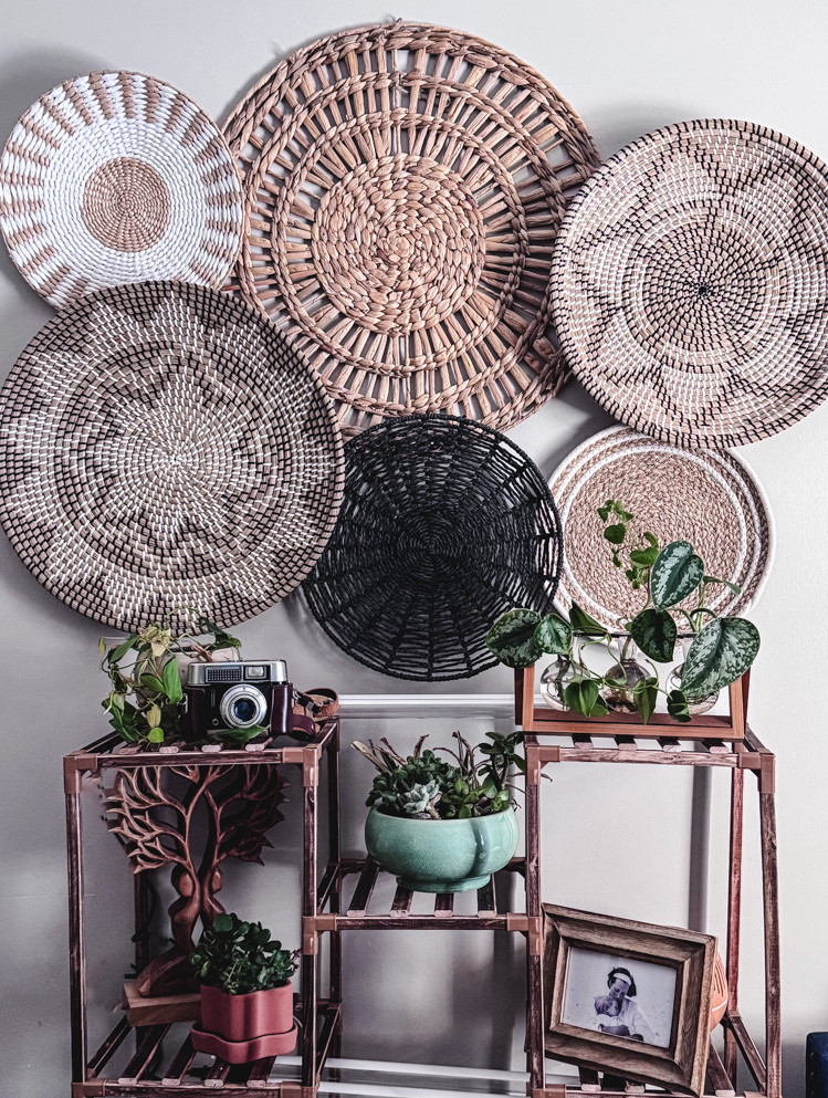 a basket wall with a plant stand beneath