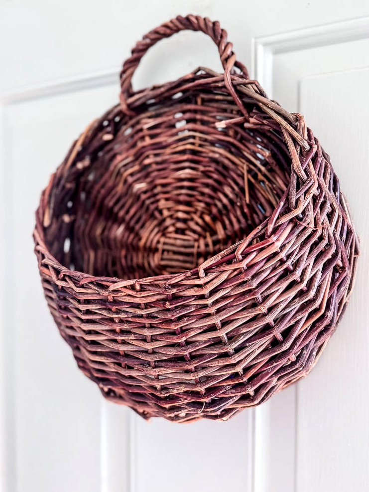 empty hanging door basket on the front door 