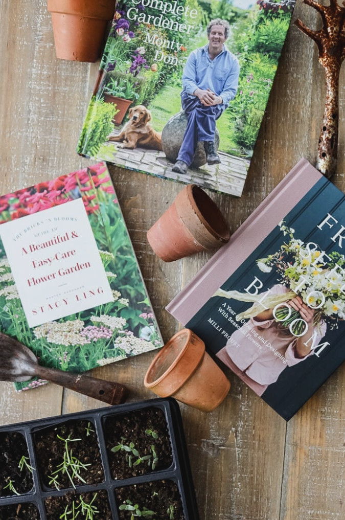 garden books, terracotta pots, and plants