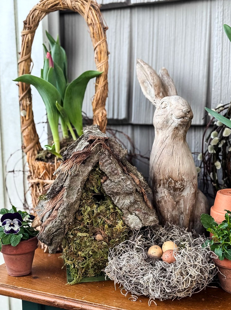 spring table featuring tulips, nest, birdhouse, and bunny statue