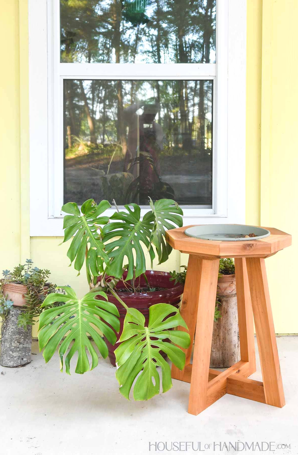 DIY wooden bird bath with a pedestal base.
