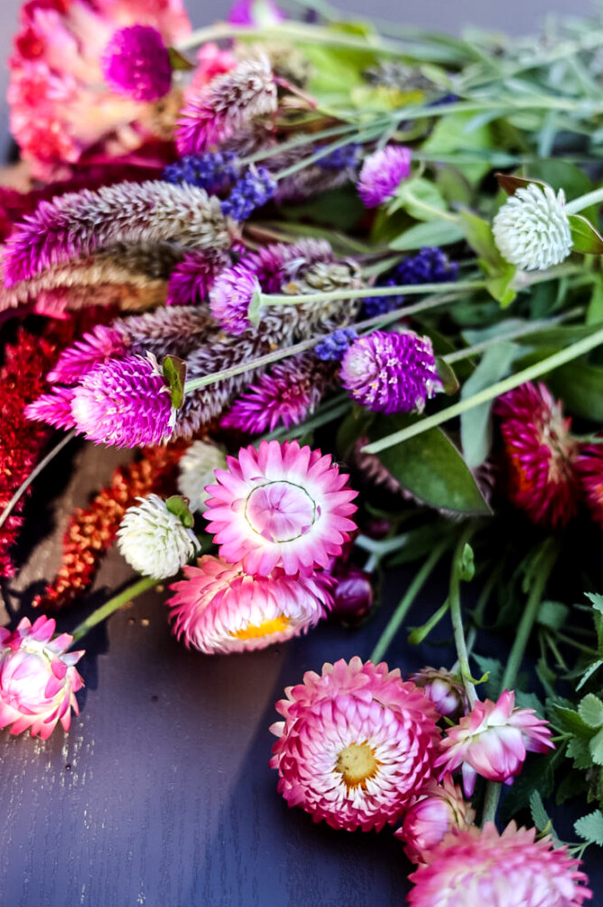 jewel colored bunch of flowers including strawflowers, gomphrena, and celosia