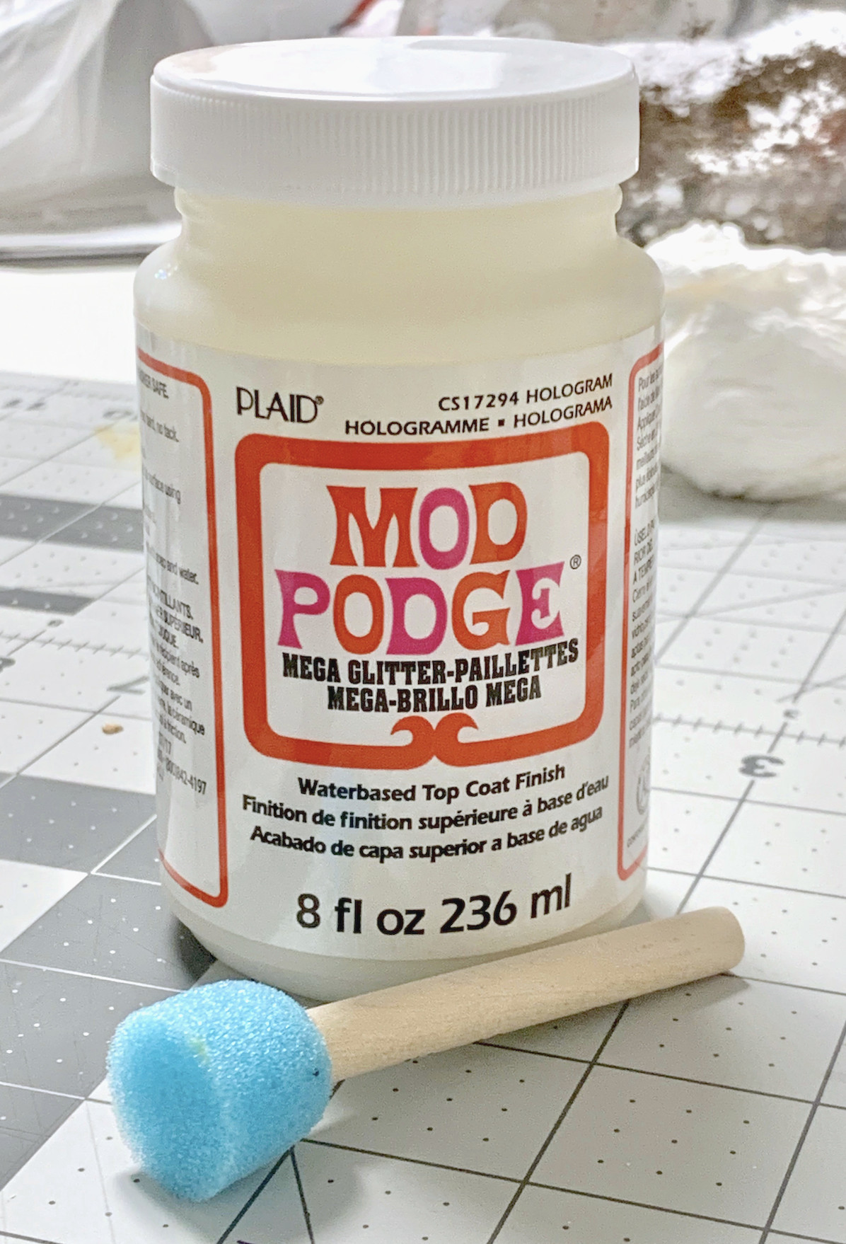 A bottle of Mega Glitter Mod Podge with a spouncer