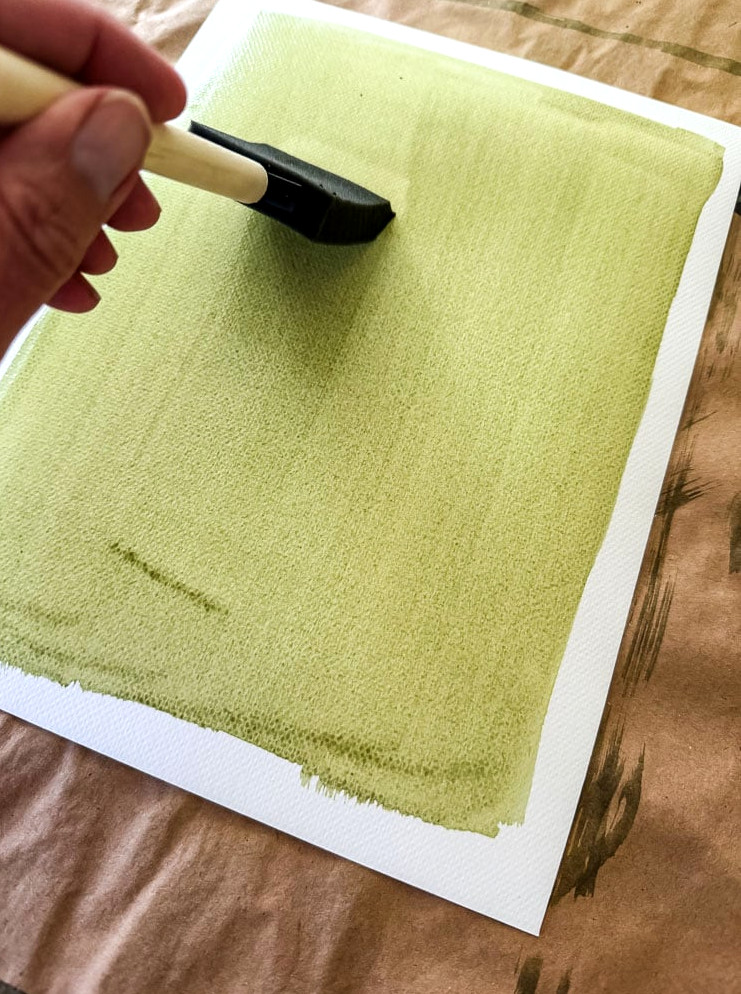 brushing cyanotype chemicals on paper